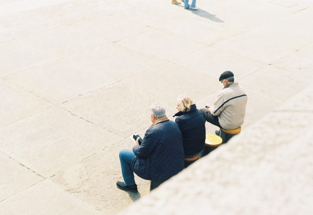 3 men sitting outside